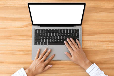 Technology Concept. Businesswoman using personal laptop with white empty monitor for mock up, top...