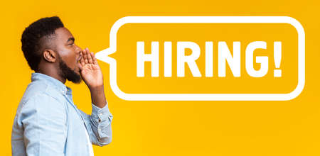 African American guy making announcement HIRING over yellow background, collage. Panorama