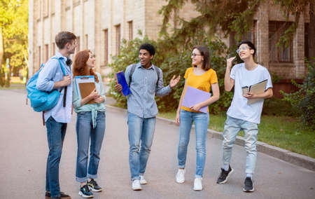 Multiethnic Freshmen Students Talking Walking In University Campus Outside. Higher Education Concept