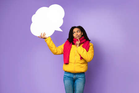 Thoughtful Black Girl Holding Blank Speech Bubble Above Head Thinking Standing Over Purple...