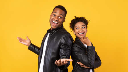 Cheerful African American Boyfriend And Girlfriend Posing Standing Back-To-Back Over Yellow...