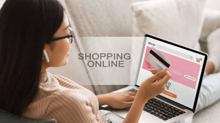 Asian Woman Doing Online Shopping Using Laptop And Credit Card Sitting On Couch At Home. Collage With Text, Panoramaの写真素材