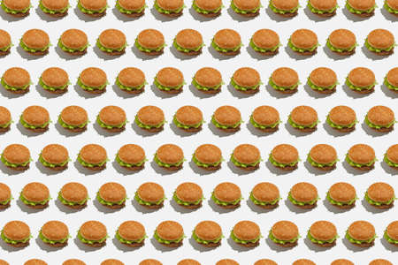 Restaurant menu and delicious junk food for client for lunch. Burger with salad on white background, seamless pattern, flat lay, wallpaperの写真素材