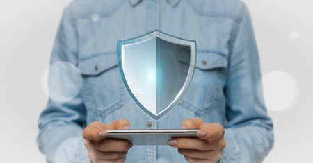 Technology And Data Protection Concept. Closeup of woman holding and using smartphone with security...