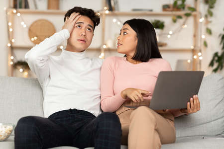 Asian Shopaholic Wife Shopping Online With Shocked Husband, Asking Him Buy Expensive Clothes And...