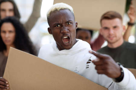 African american emotional man leading international group of strikers with empty placards on the...