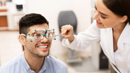 Eyesight Test, Medical Examination Concept. Portrait of smiling specialist female optometrist...
