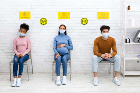 Coronavirus Vaccination Campaign. Multiracial People Waiting For Covid-19 Vaccination Sitting In...