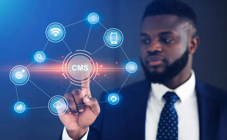 Content management system, PR strategy and SEO service concept. African American sysadmin pushing CMS button on imaginary screen with digital icons, panorama. Collageの写真素材