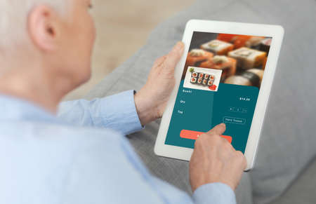 Simple application for online ordering and delivery of food for senior people. Elderly man uses...