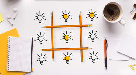 Creative Ideas Competition. Tic-Tac-Toe Of Lightbulbs On White Office Desk Background. Creativity,...