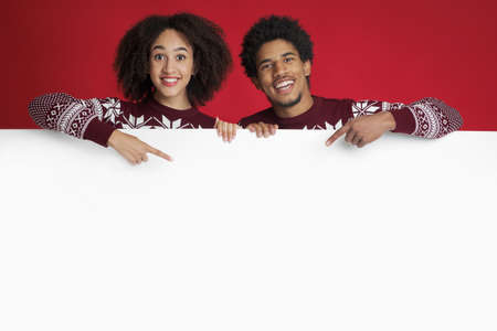 Happy New Year and winter holidays celebration. Smiling millennial african american lady and man in...