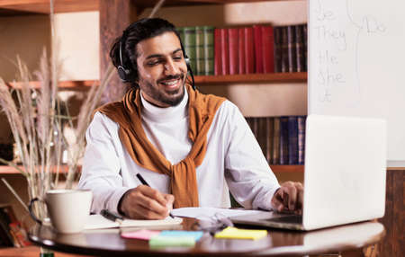 Cheerful Indian Teacher At Laptop Computer Teaching Online Having Remote Class With Distant Student...