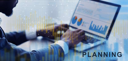 Black Businessman Working On Laptop With Financial Graphs And Charts, Analyzing Economics Statistics...