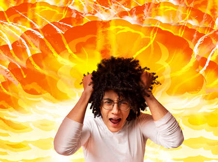 Emotional African American guy pulling his hair in anger and screaming on explosion background,...