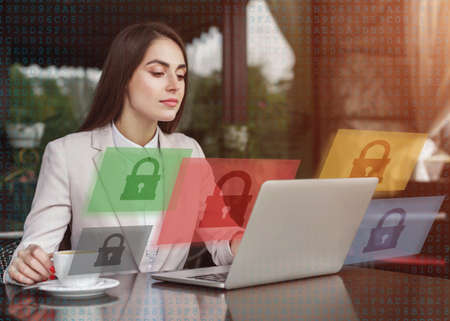 Work with blocked applications or cybersecurity. Busy business woman sitting at table in cafe, with...