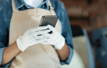 Work in catering and cafe, small business during covid-19 pandemic and social networks. Young lady...