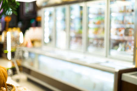 Blurred Supermarket Aisle Background With Refrigerators And Food Products On Shelves In Grocery Store. Abstract Defocused Shot, Groceries Shopping Concept, No Peopleの写真素材