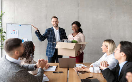 HR Manager Introducing New Female Employee To Multiracial Colleagues Team During Corporate Meeting...