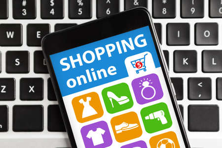 Smartphone With Mobile Application For Online Shopping Lying On Computer Keyboard Background. Internet Shop App For Cellphone Concept. Cropped, Collageの写真素材
