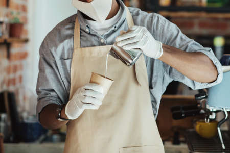 Preparing coffee for client and new normal during covid-19 quarantine. Millennial african american...