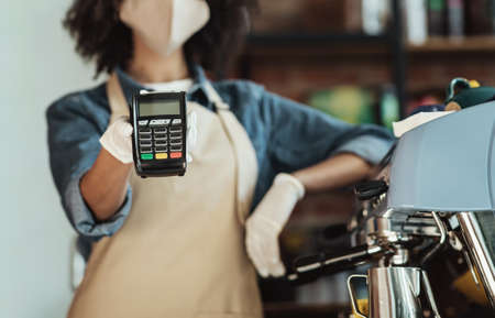 Modern fast pay for takeaway order during COVID-19 pandemic and social distancing. Millennial...