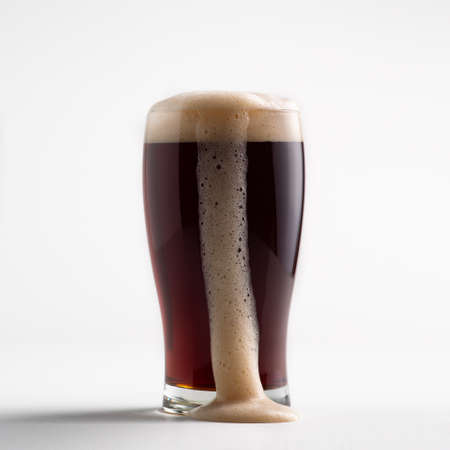 Delicious fresh ale and tasty drink for client in pub or offer of lager. Cold full glass of dark...