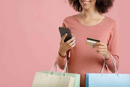 Mobile app, black friday and modern shopping. Happy millennial african american lady holding colored...