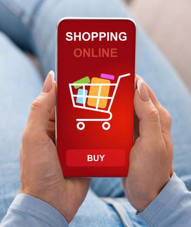 Unrecognizable Lady Shopping Online Via Smartphone Buying Grocery Products In Mobile App Sitting On Sofa At Home. Mobile Shop Application, Sales And Discounts. Vertical, Cropped, Selective Focusの写真素材