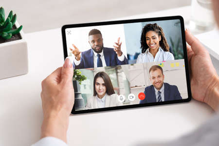 Business People Having Group Video Call Online Via Digital Tablet During Distant Corporate Meeting...