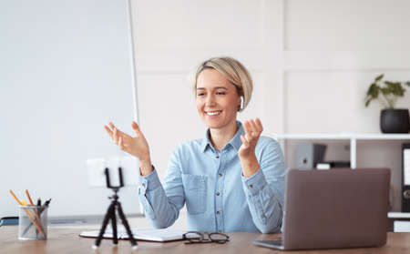 Online tutoring and remote education concept. Friendly female tutor having video call with students,...