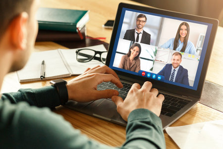 Online Business Meeting Via Video Call. Man At Laptop Communicating With Remote Colleagues...