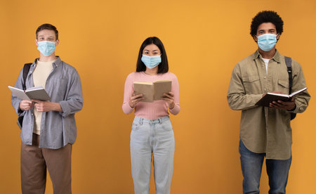 New normal, education and covid-19 pandemic. Young european, asian and african american students in...