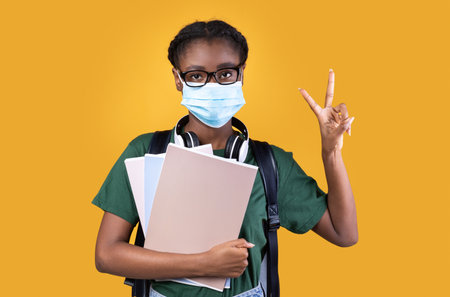 Coronavirus Protection. Positive African American Female Student Wearing Protective Face Mask And...