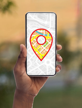 Gps Maps App With Pinpoint Icon On Screen Opened On Smartphone In Black Female Hand, Creative Collage For Modern Navigation Application Or Geolocation Service, Closeupの写真素材