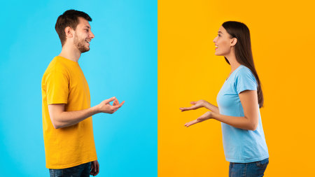 Communication. Profile portrait of casual woman and bearded smiling caucasian man talking isolated over halved blue and yellow studio background. Side view of positive couple discussingの写真素材