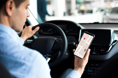 Man Using Gps App On Smartphone While Driving Car, Enjoying Modern Technologies For Navigation And...