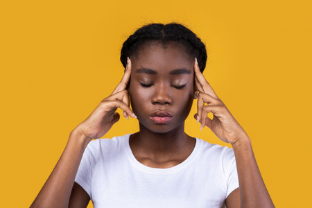 Thoughtful African Female Thinking Massaging Temples With Fingers, Posing With Eyes Closed Standing...