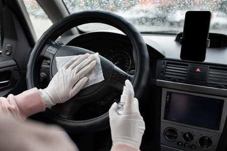 Work as taxi driver and disinfection during covid quarantine. Millennial african american female in...