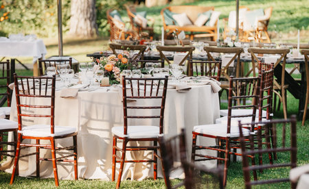 Boho design and rustic outdoor wedding at good sunny day in summer. Candles, bouquets, napkins,...