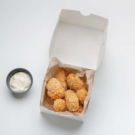 Fried crispy snacks and fast food delivery, yummy online order. Savory nuggets in paper box and...