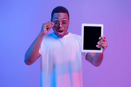 Check This. Amazed African American Guy In Stylish Eyeglasses Holding Digital Tablet With Black...