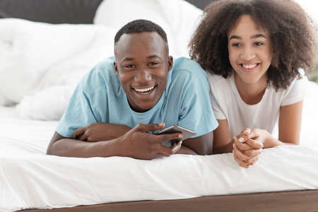 Cheerful romantic couple carefree young husband and wife enjoy weekend morning laughing, bonding,...