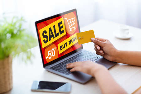 Black lady shopping on Internet at home