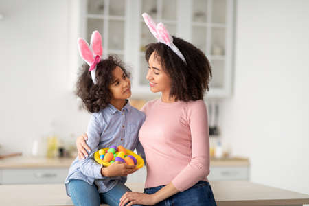 Black girl and lady wearing bunny ears on Easter dayの写真素材