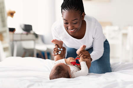 African American woman playing with her little baby