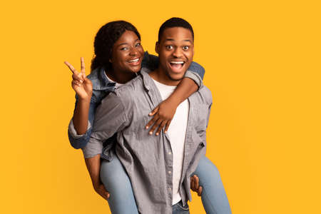 Happy African American Couple Having Fun Together, Black Guy Piggybacking His Girlfriendの写真素材