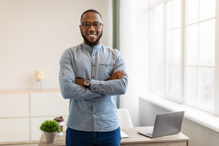 Successful African American Businessman Posing Standing In Modern Officeの写真素材