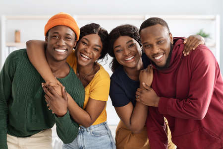 Portrait of positive african american couples, home interiorの写真素材