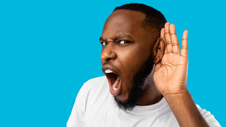 Funny Black Guy Listening Holding Hand Near Ear, Blue Background